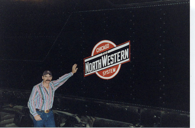026a.jpg.jpg - Brian Bowen of the Forney Museum, Denver, Colorado, leans against the tender of C&NW 444, an oil burning R-1.  Good to see that herald again!  Wally caught Brian in September 2004.
